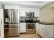Kitchen with stainless steel appliances, white cabinets, and tile flooring at 7285 E County Road 900 N, Brownsburg, IN 46112