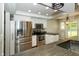 Modern kitchen features stainless steel appliances, white cabinetry, and stylish lighting at 7285 E County Road 900 N, Brownsburg, IN 46112