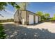 Exterior view of a two-car garage outbuilding with gravel driveway and partial fence at 7285 E County Road 900 N, Brownsburg, IN 46112