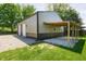 Exterior of two-tone garage with 2-car bays and covered area with grass and gravel surroundings at 7285 E County Road 900 N, Brownsburg, IN 46112
