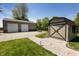 Exterior view of a large garage outbuilding and a small shed on a gravel drive and grass at 7285 E County Road 900 N, Brownsburg, IN 46112