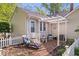 Charming backyard with a brick patio, pergola, lounge chair, and white picket fence at 744 Gilbert Ave, Indianapolis, IN 46227