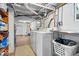 Basement features laundry area with white washer and dryer units and utilitarian decor at 744 Gilbert Ave, Indianapolis, IN 46227