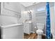 Bathroom with laundry with stacked washer and dryer, sink, toilet, and tub at 744 Gilbert Ave, Indianapolis, IN 46227