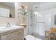 Bathroom featuring white vanity, glass door walk-in shower, mosaic tile floor, and chrome fixtures at 744 Gilbert Ave, Indianapolis, IN 46227