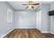 Simple bedroom with a wooden floor, ceiling fan, and white trim at 744 Gilbert Ave, Indianapolis, IN 46227