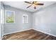 Small bedroom with hardwood floors, white trim, a ceiling fan and a window at 744 Gilbert Ave, Indianapolis, IN 46227