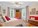Bedroom featuring a ceiling fan, neutral walls, hardwood floors, bright windows with curtains and decorations at 744 Gilbert Ave, Indianapolis, IN 46227