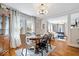 Open dining and living room featuring hardwood floors, large windows with curtains, and neutral walls at 744 Gilbert Ave, Indianapolis, IN 46227