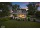 Charming home at dusk with professionally landscaped front yard at 744 Gilbert Ave, Indianapolis, IN 46227