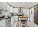 Updated kitchen featuring white cabinets, a kitchen island, and modern appliances at 744 Gilbert Ave, Indianapolis, IN 46227