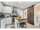 Updated kitchen featuring white cabinets, stainless steel appliances, kitchen island, and rustic sliding barn door at 744 Gilbert Ave, Indianapolis, IN 46227