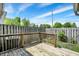 Wooden deck surrounded by a wooden fence and greenery, offering a private outdoor space at 7642 Lancer Ln, Lawrence, IN 46226