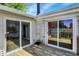 Corner view of a back deck, featuring two sliding glass doors and weathered wooden planks at 7642 Lancer Ln, Lawrence, IN 46226