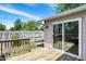 A wooden deck showcases a sliding glass door and wooden railing overlooking the backyard at 7642 Lancer Ln, Lawrence, IN 46226