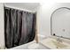 Bathroom featuring a bathtub, arched mirror, granite countertop and updated fixtures at 7642 Lancer Ln, Lawrence, IN 46226