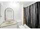 Bathroom featuring an arched mirror, granite countertop, and a shower and tub combo at 7642 Lancer Ln, Lawrence, IN 46226