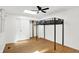 Bedroom with a unique loft bed, skylight, hardwood floors and a closet at 7642 Lancer Ln, Lawrence, IN 46226
