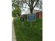 A couple of community informational and security signs are posted in the grass at 7642 Lancer Ln, Lawrence, IN 46226