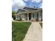 Charming brick home exterior with manicured lawn, walkway, and inviting front entrance at 7642 Lancer Ln, Lawrence, IN 46226