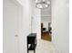 Bright foyer featuring a chandelier, tile flooring, with an open view into the living room at 7642 Lancer Ln, Lawrence, IN 46226