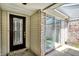 Exterior view of a front door featuring a decorative glass insert with a large sliding glass door at 7642 Lancer Ln, Lawrence, IN 46226