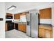 Well-lit kitchen with stainless steel appliances, wood cabinets, and light countertops at 7642 Lancer Ln, Lawrence, IN 46226