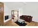 Living room with fireplace, glass coffee table, and french doors at 7642 Lancer Ln, Lawrence, IN 46226