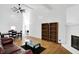 Bright living room with a fireplace, wood floors, and contemporary furnishings at 7642 Lancer Ln, Lawrence, IN 46226