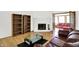 Bright living room with a brick fireplace and bookshelf at 7642 Lancer Ln, Lawrence, IN 46226