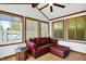 Comfortable sunroom with ample natural light and a ceiling fan at 7642 Lancer Ln, Lawrence, IN 46226