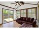 Cozy sunroom with natural lighting, ceiling fan, and patio door at 7642 Lancer Ln, Lawrence, IN 46226