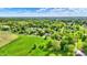 Picturesque aerial view of homes amid lush greenery with scattered trees, and nearby open fields, creating a serene environment at 7655 N Kitchen Rd, Mooresville, IN 46158
