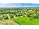 Picturesque aerial view of a neighborhood and open field with verdant trees, showcasing a calm and idyllic setting at 7655 N Kitchen Rd, Mooresville, IN 46158