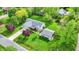 Aerial view of a home with mature trees, green lawn, and detached garage nestled in a serene landscape at 7655 N Kitchen Rd, Mooresville, IN 46158