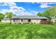 Spacious backyard featuring a well-maintained lawn, mature trees, and a wooden deck perfect for enjoying the outdoors at 7655 N Kitchen Rd, Mooresville, IN 46158