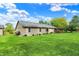 Backyard featuring green lawn, home's exterior, and wooden deck, perfect for outdoor entertaining and relaxation at 7655 N Kitchen Rd, Mooresville, IN 46158