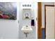 Charming powder room with stylish sink, decorative mirror and adjacent doorway at 7655 N Kitchen Rd, Mooresville, IN 46158