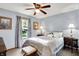 Comfortable bedroom with patterned bedding, soft lighting, and windows offering serene views at 7655 N Kitchen Rd, Mooresville, IN 46158