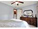 Cozy bedroom with dresser, ceiling fan, and window view, creating a relaxing retreat at 7655 N Kitchen Rd, Mooresville, IN 46158