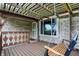 Relaxing covered porch with a swing, offering a cozy outdoor space with views of the yard at 7655 N Kitchen Rd, Mooresville, IN 46158