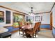Formal dining room with elegant chandelier, wood trim, and natural light at 7655 N Kitchen Rd, Mooresville, IN 46158
