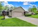 Attractive single-story home with attached garage, screened in porch and well-maintained landscaping at 7655 N Kitchen Rd, Mooresville, IN 46158