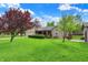 Beautiful ranch home with a well-manicured lawn, mature trees, and a welcoming covered porch at 7655 N Kitchen Rd, Mooresville, IN 46158