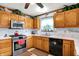 Kitchen features a stainless steel stove, oak cabinets, and neutral countertops at 7655 N Kitchen Rd, Mooresville, IN 46158