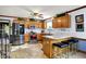 Functional kitchen with stainless steel appliances, wood cabinets, and breakfast bar at 7655 N Kitchen Rd, Mooresville, IN 46158