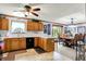 The kitchen overlooks the adjacent dining room, wood cabinets, and breakfast bar seating at 7655 N Kitchen Rd, Mooresville, IN 46158