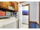 Convenient laundry area features wood cabinetry and modern washer/dryer for efficient chore management at 7655 N Kitchen Rd, Mooresville, IN 46158