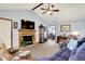 Warm living room featuring a fireplace, vaulted ceiling, and views into the dining area at 7655 N Kitchen Rd, Mooresville, IN 46158