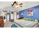 Bright main bedroom featuring a vaulted ceiling, ceiling fan, and colorful wall art above the bed at 7655 N Kitchen Rd, Mooresville, IN 46158